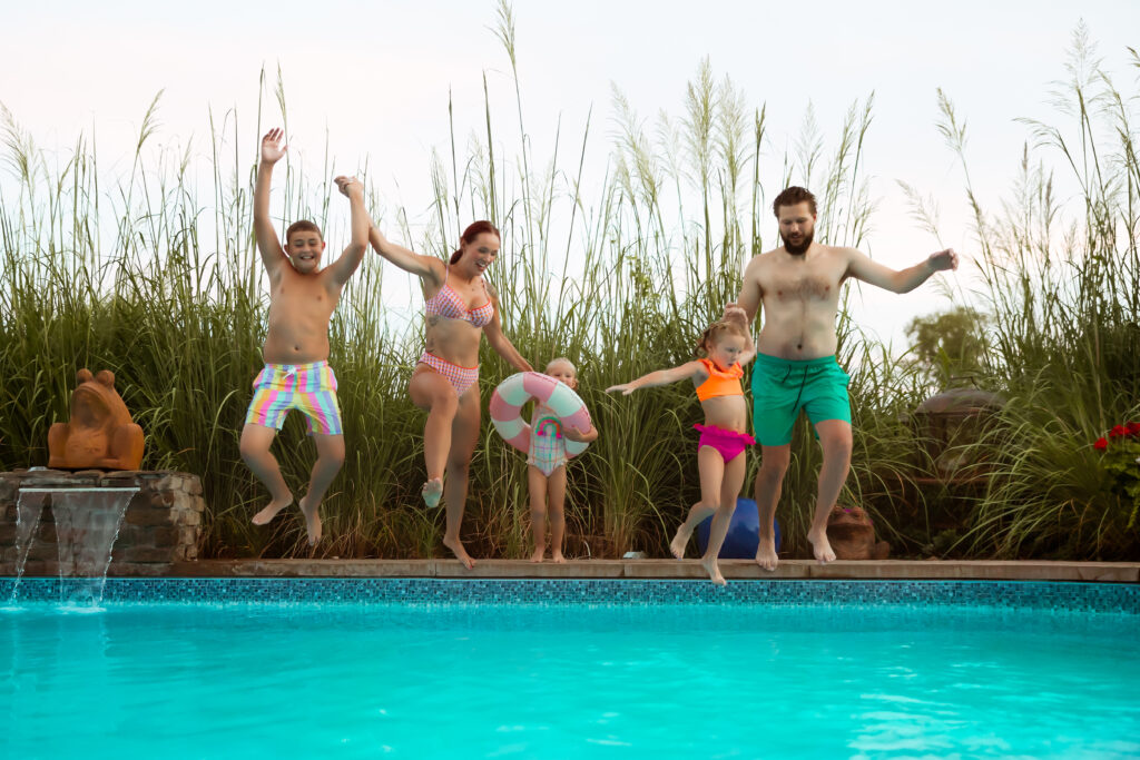 If you search Family Photos Near Me in Kansas City you'll find photographers that want their families to have fun and jump in a swimming pool together as a family during their at home backyard family session.